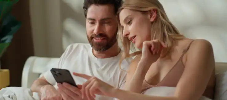 couple looking at mobile device together