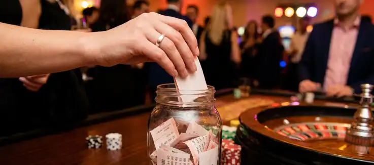 woman picking a paper out of a lottery bowl